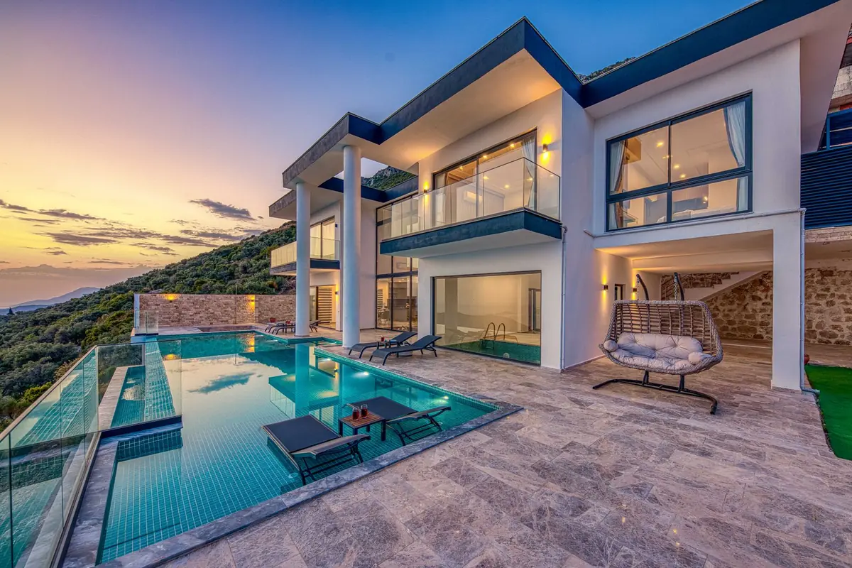 Modern villa with an infinity pool at dusk